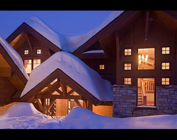 snow-covered log home dormers