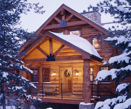 Front entry of snow covered cabin