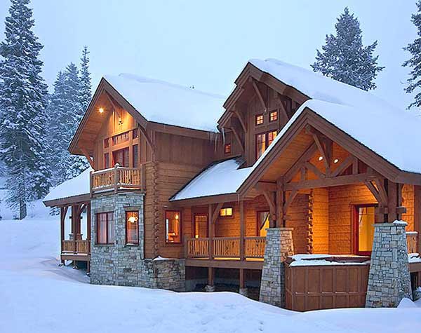 snow covered log home
