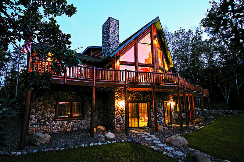 half-log house with simulated river rock