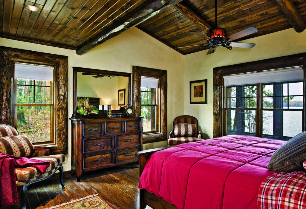 Lakeside bedroom wood beams red bedspread
