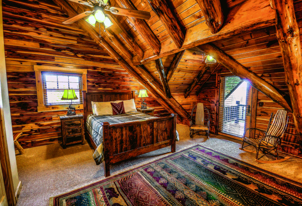 log home bedroom knotty wood bed rug rocking chair