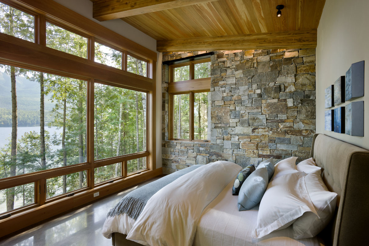 timber home log home luxury bedroom windows bed stone wall